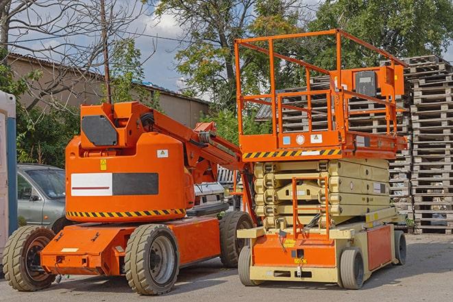 forklift carrying heavy pallets in warehouse in Alden